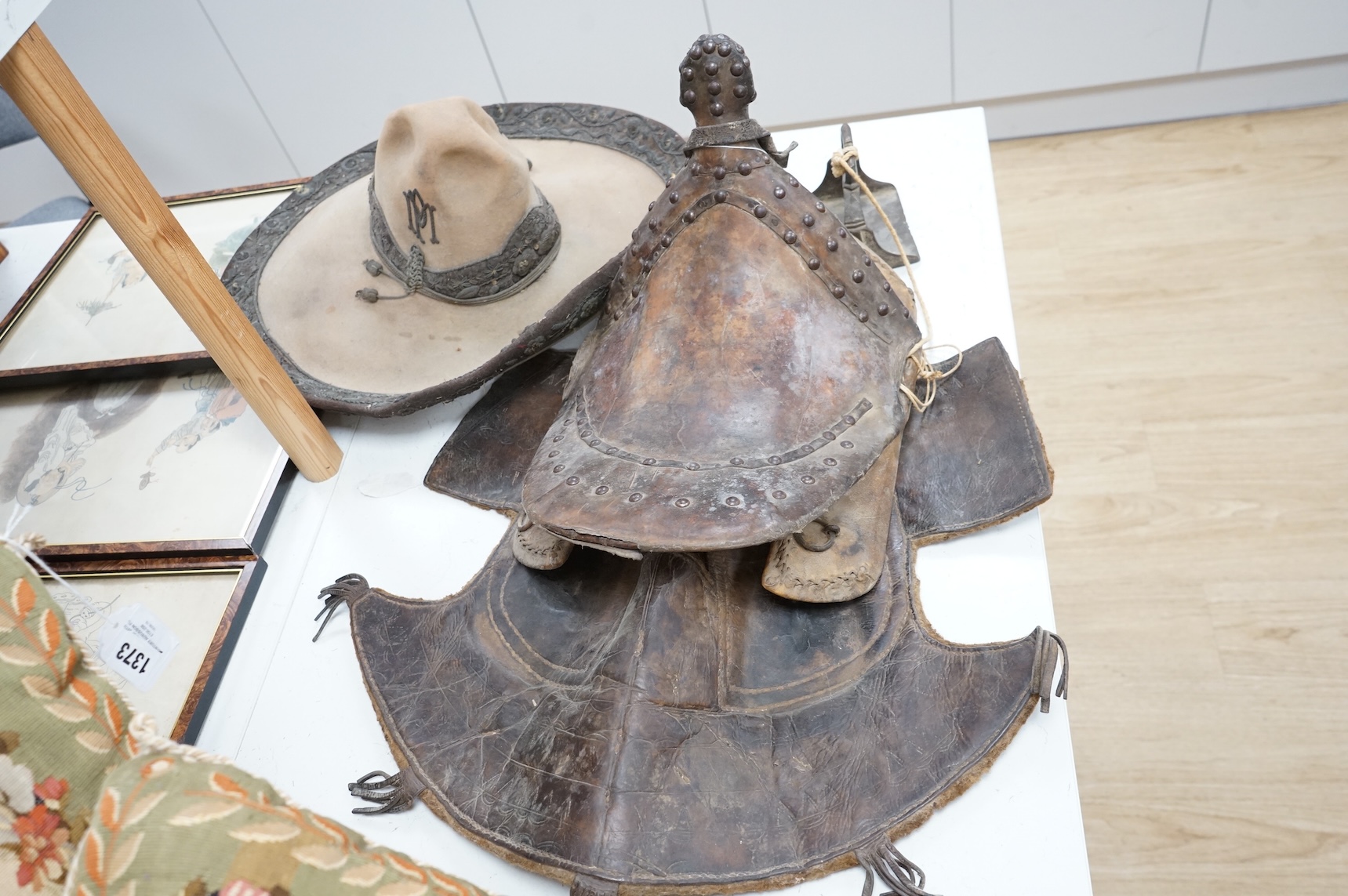 A Spanish Colonial leather saddle and a Spanish Colonial bullion work sombrero, saddle 59cm long